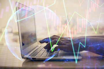 Double exposure of woman hands typing on computer and forex chart hologram drawing. Stock market invest concept.