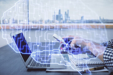 Double exposure of man's hand holding and using a digital device and brain hologram drawing. Data concept.
