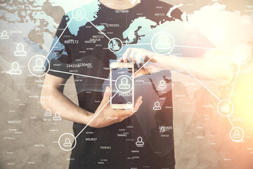 Double exposure of man's hands holding and using a phone and social network theme drawing.