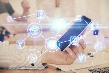 Double exposure of man's hands holding and using a phone and social network theme drawing.