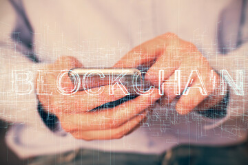 Double exposure of man's hands holding and using a phone and crypto currency blockchain theme drawing.