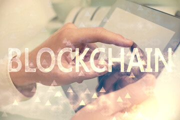 Double exposure of man's hands holding and using a phone and crypto currency blockchain theme...