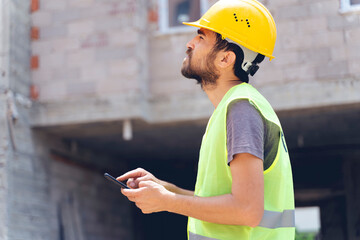 builder with van checking text messages on mobile phone