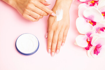 Obraz na płótnie Canvas Hand skin care, woman applies moisturizer on soft silky skin