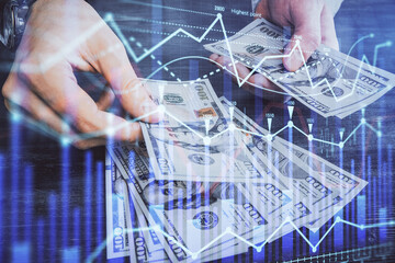 Multi exposure of financial graph drawing hologram and USA dollars bills and man hands. Analysis concept.
