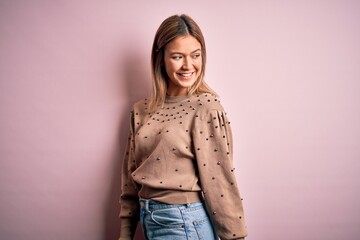 Young beautiful woman wearing fashion urban clothes, model wearing casual street style standing over pink background