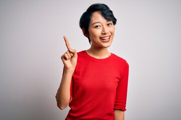 Young beautiful asian girl wearing casual red t-shirt standing over isolated white background...