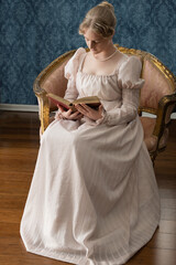 A young Regency period woman in a pale pink gown