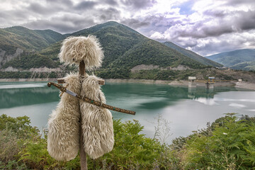 mountain landscape with lake and national  georgian clothes 