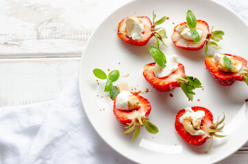 plate with fresh strawberry with cream cheese, balsamic vinegar and basil