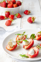 plate with fresh strawberry with cream cheese, balsamic vinegar and basil