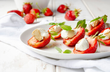 plate with fresh strawberry with cream cheese, balsamic vinegar and basil