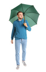 Handsome young man with umbrella on white background