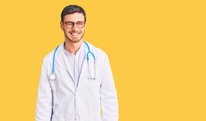 Handsome young man with bear wearing doctor uniform winking looking at the camera with sexy...