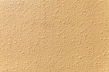 Yellow painted cement wall texture and seamless background