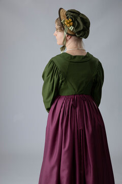 A Young Regency Period Woman In A Deep Maroon Red Gown