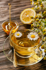 Cup of chamomile tea on wooden background