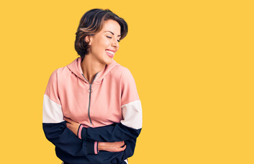 Young beautiful woman wearing sportswear smiling and laughing hard out loud because funny crazy...