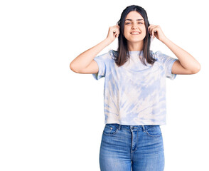 Young beautiful girl wearing casual t shirt smiling pulling ears with fingers, funny gesture....