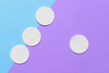 Cotton cosmetic pads on color background