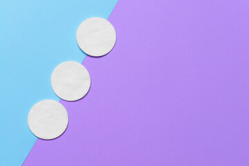 Cotton cosmetic pads on color background