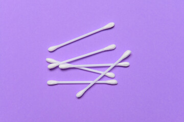 Cotton cosmetic swabs on color background