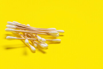 Cotton cosmetic swabs on color background