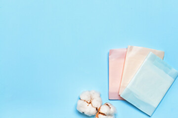 Cotton menstrual pads on color background