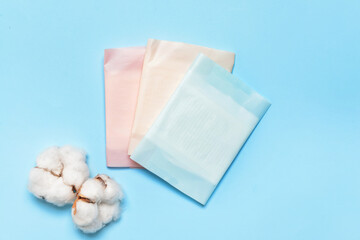 Cotton menstrual pads on color background