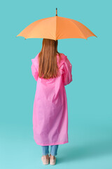 Beautiful woman with umbrella on color background, back view