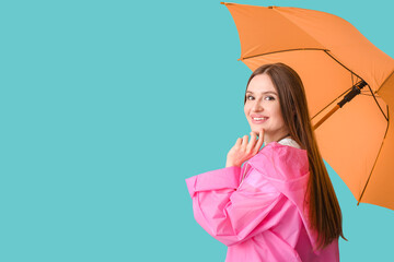 Beautiful woman with umbrella on color background