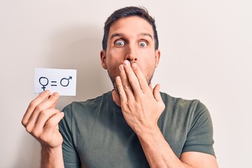 Young handsome man asking for sex discrimination holding paper with gender equality message...