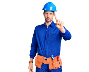 Young handsome man wearing worker uniform and hardhat rejection expression crossing arms doing negative sign, angry face