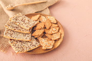 Plate with cereal cookies on color background