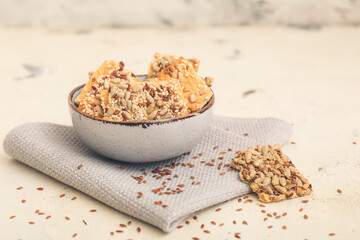 Bowl with cereal cookies on color background