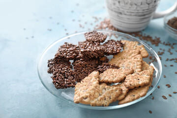 Plate with cereal cookies on color background