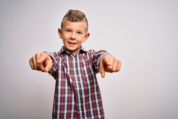 Young little caucasian kid with blue eyes wearing elegant shirt standing over isolated background pointing to you and the camera with fingers, smiling positive and cheerful