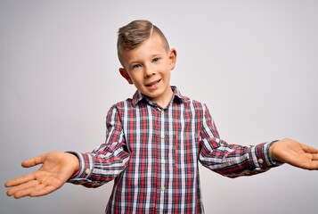 Young little caucasian kid with blue eyes wearing elegant shirt standing over isolated background smiling cheerful offering hands giving assistance and acceptance.