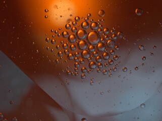 Closeup orange bubbles oil with soft focus and blurred background ,macro image ,abstract background ,water droplets, soap bubbles ,sweet color for card design water drops on glass