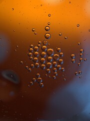 Closeup orange bubbles oil with soft focus and blurred background ,macro image ,abstract background ,water droplets, soap bubbles ,sweet color for card design water drops on glass