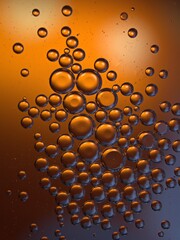 Closeup orange bubbles oil with soft focus and blurred background ,macro image ,abstract background ,yellow gold water droplets, soap bubbles ,sweet color for card design water drops on glass