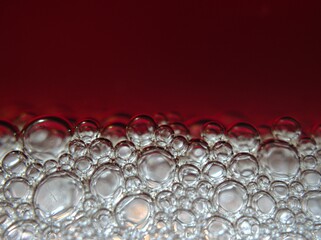 Closeup beautiful white red bubbles abstract blurred background with macro image ,shiny coffee...