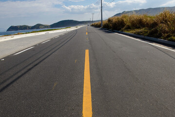 simple road with yellow strip dividing the lanes.
