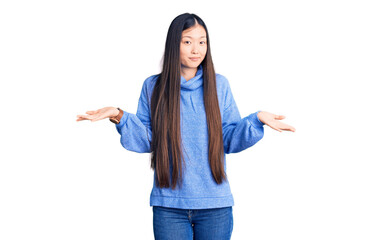 Young beautiful chinese woman wearing casual turtleneck sweater clueless and confused expression...