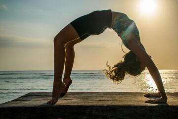 healthy yoga woman model backbend sunset