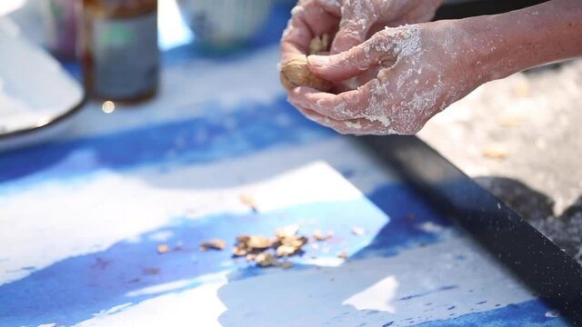 opening walnuts with both hands