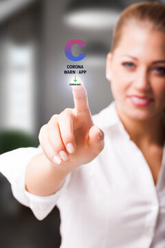 woman is touching a virtual button to download the CORONA WARN APP