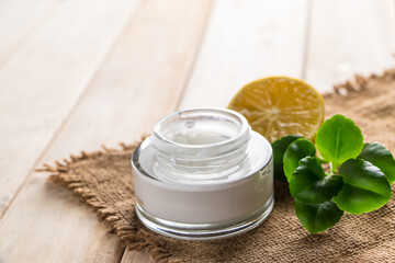 Health care concept. Organic cosmetics with lemon. Product for spa and aromatherapy. Natural moisturizer on wooden background.