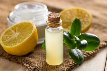 Obraz na płótnie Canvas Health care concept. Organic cosmetics with lemon. Natural moisturizer on wooden background.