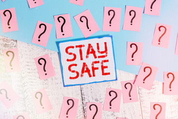 Writing note showing Stay Safe. Business concept for secure from threat of danger, harm or place to...